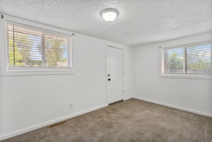 Neutral-toned carpeting complements bright white walls and trim