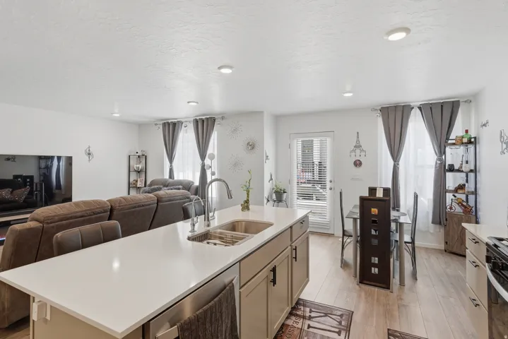 Kitchen island with a light-toned countertop and an undermount double sink