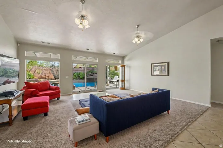 Spacious living area featuring high vaulted ceilings and light-toned walls