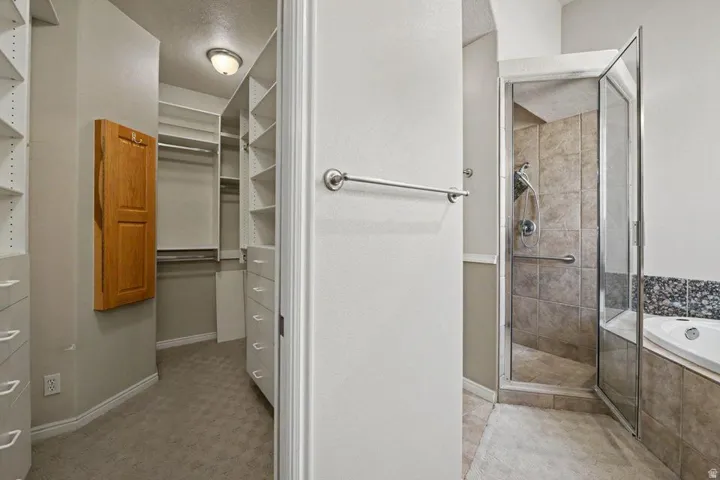 Custom closet system with multiple shelving units, drawers, and hanging rods