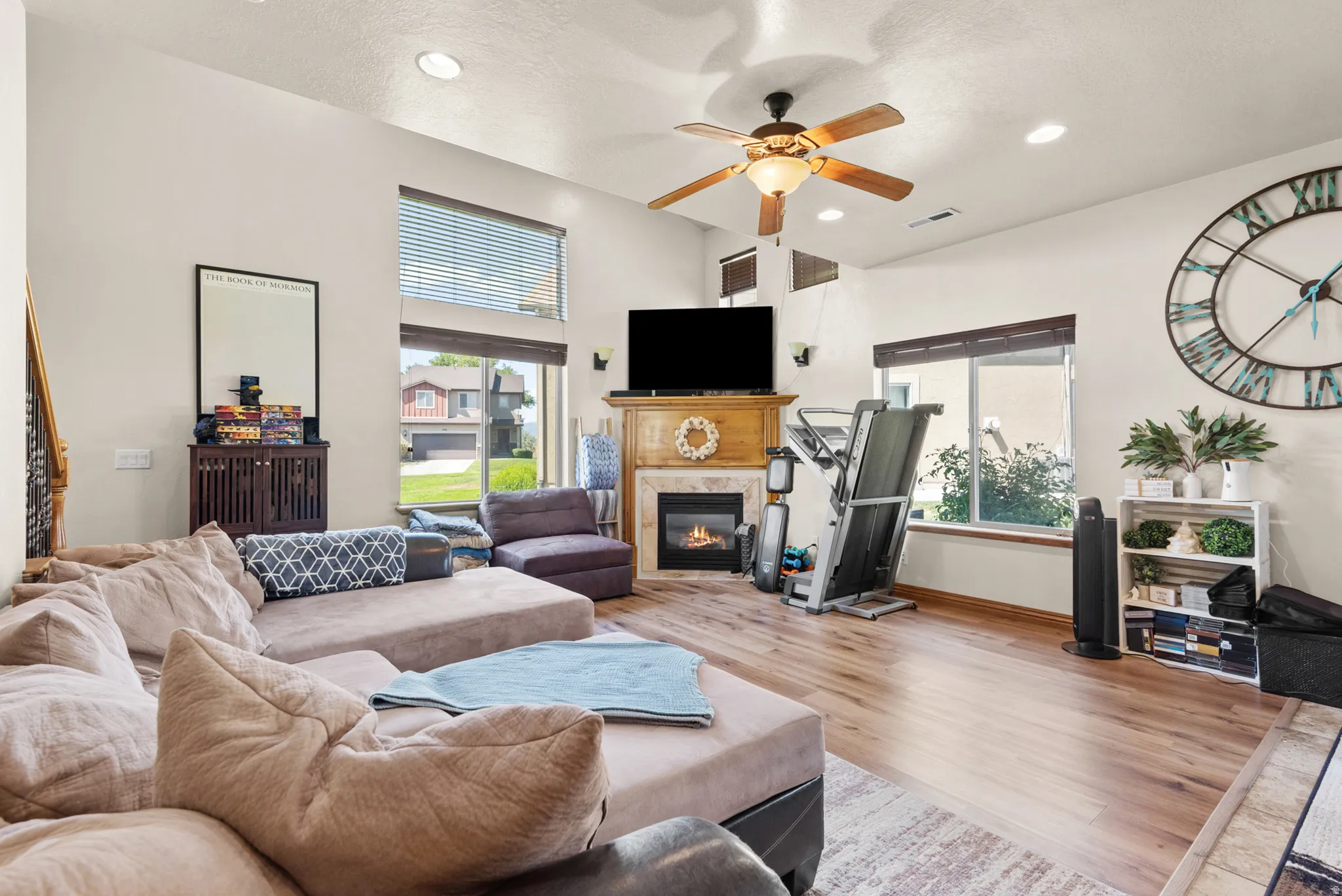 Spacious living area featuring high ceilings, recessed lighting, and wood-finish flooring