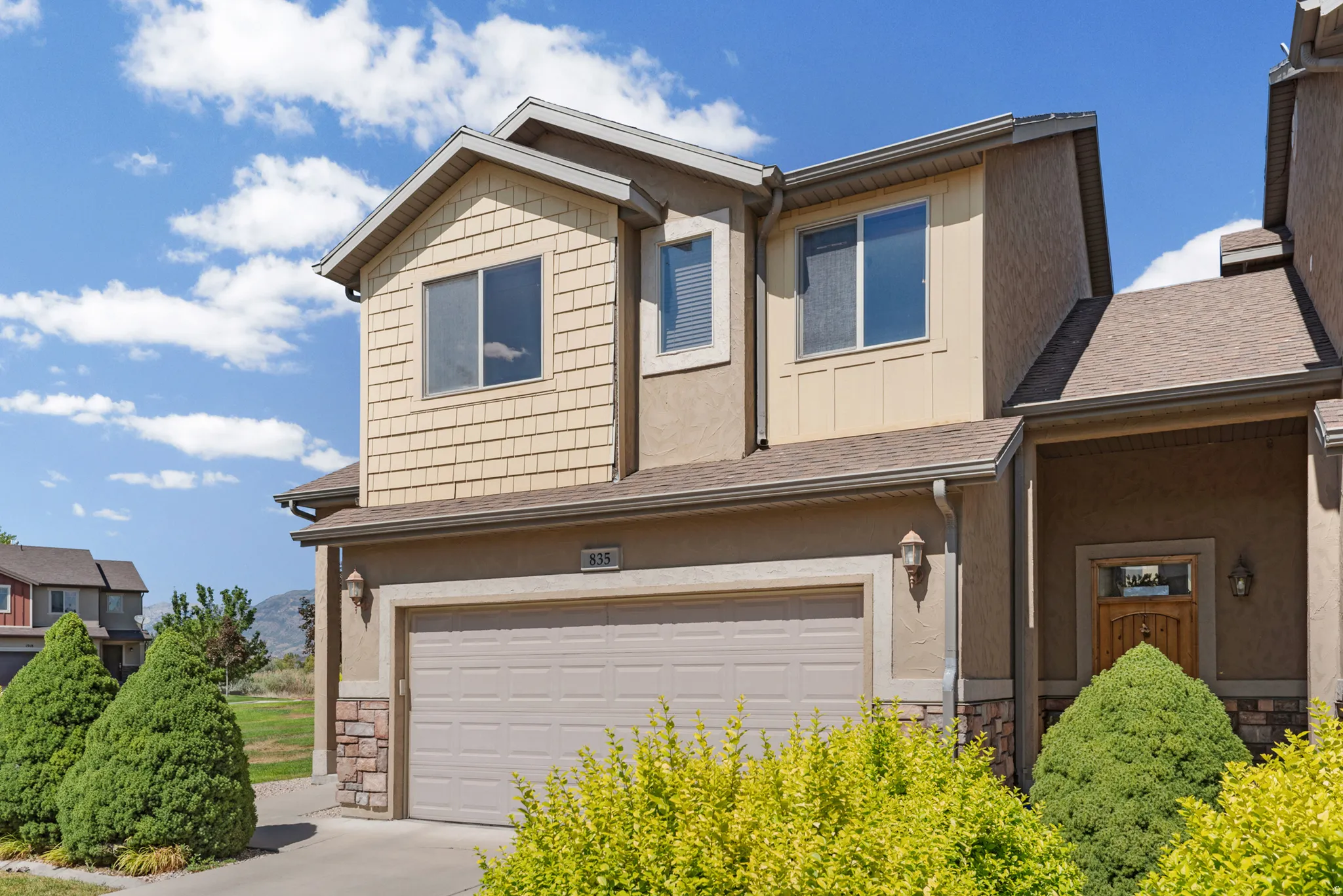 Multi-level stucco exterior with stone veneer accents