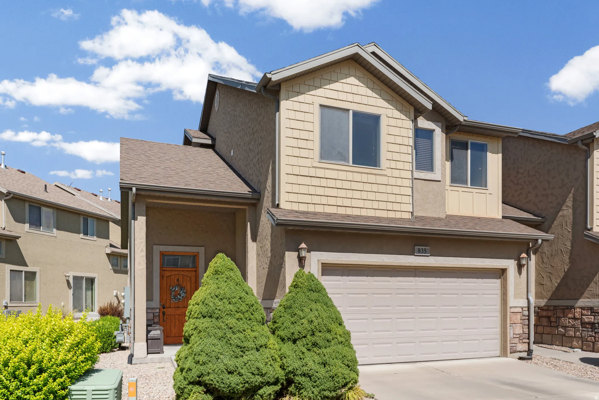 Two-story residence featuring a combination of stucco and shake siding