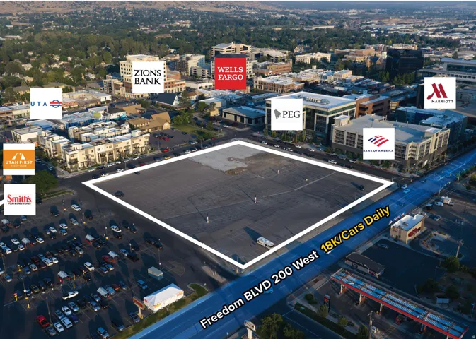 Expansive commercial parcel featuring paved surfaces and a concrete pad