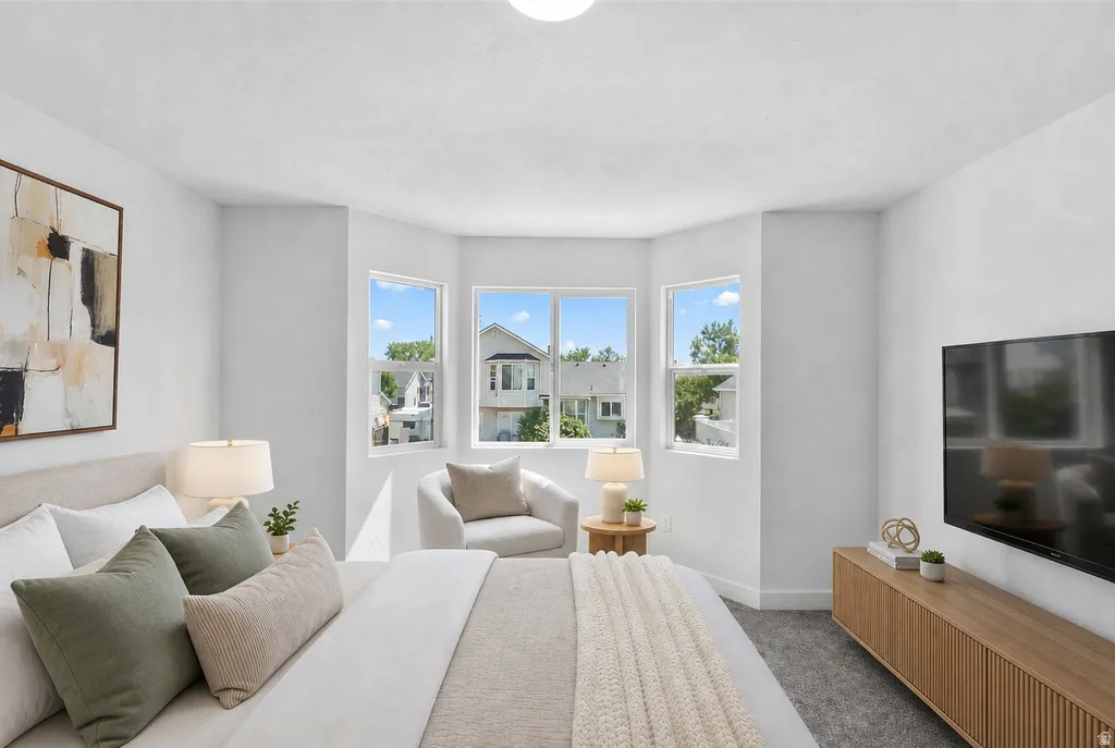 Bright room with light grey carpet and white walls