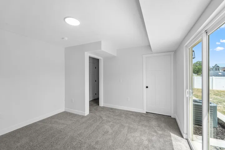 Carpeted interior space with white walls and trim