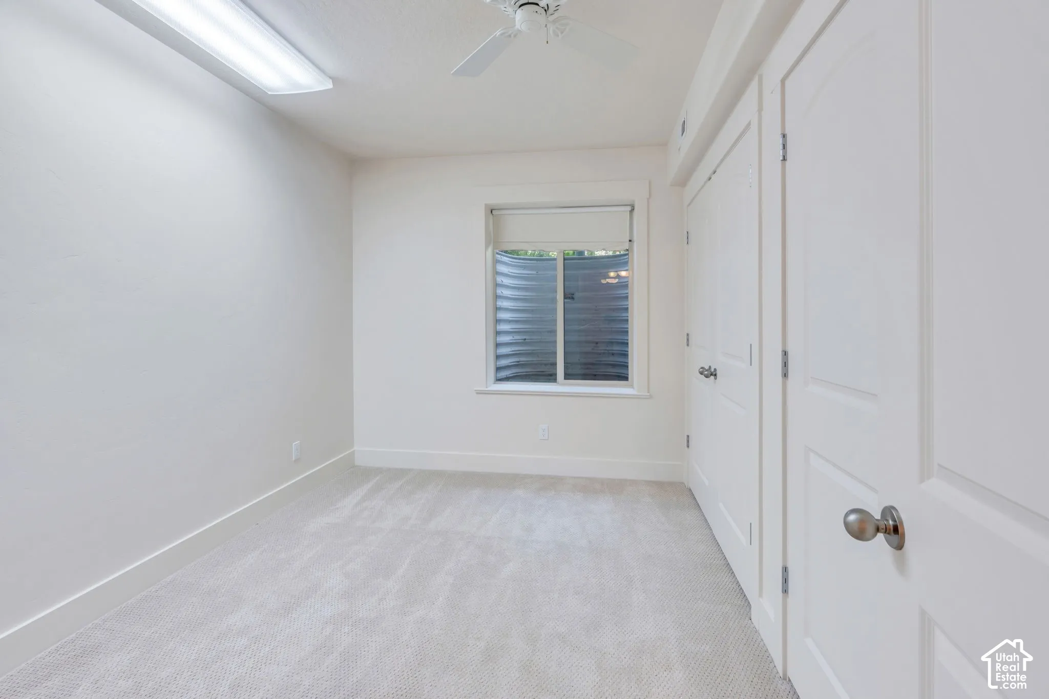 Neutral-toned carpeting, white walls, and bright white trim
