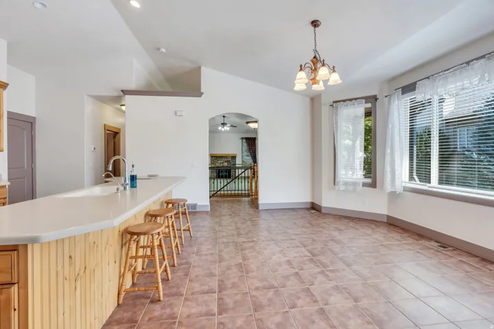 Kitchen island with beadboard paneling, light-toned countertop, and integrated sink