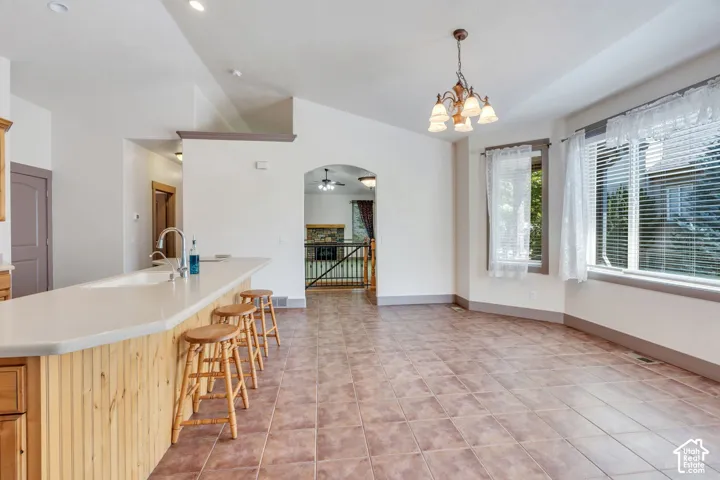 Kitchen island with beadboard paneling, light-toned countertop, and integrated sink