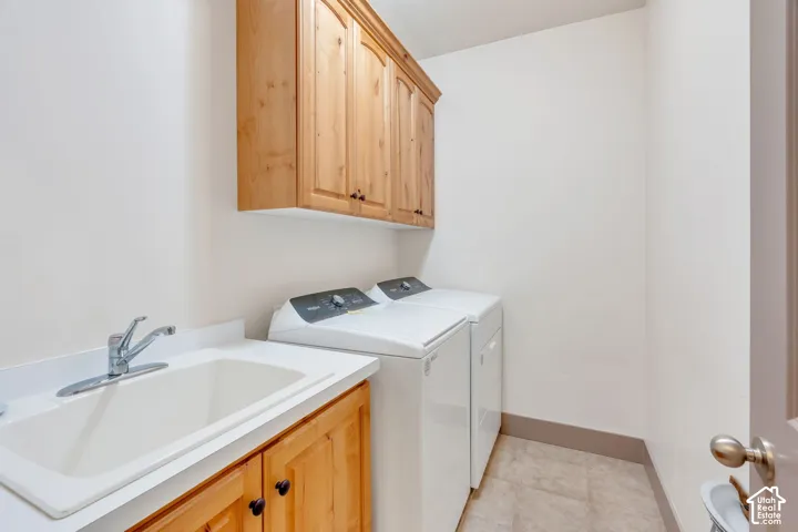 Utility room with a built-in sink, white countertop, and natural wood cabinetry