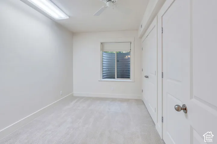 Neutral-toned carpeting, white walls, and bright white trim