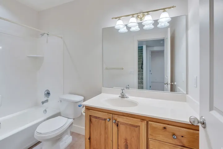Full bathroom featuring a white tub/shower combination with chrome fixtures