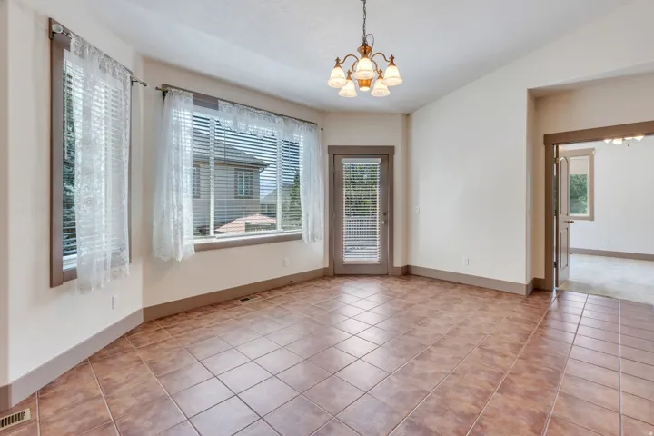Spacious room featuring neutral-toned walls and durable tile flooring