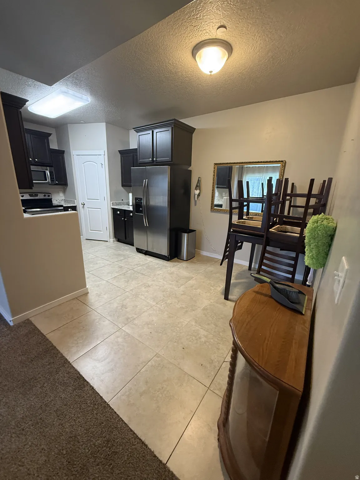Tile flooring extending from the kitchen into the dining area