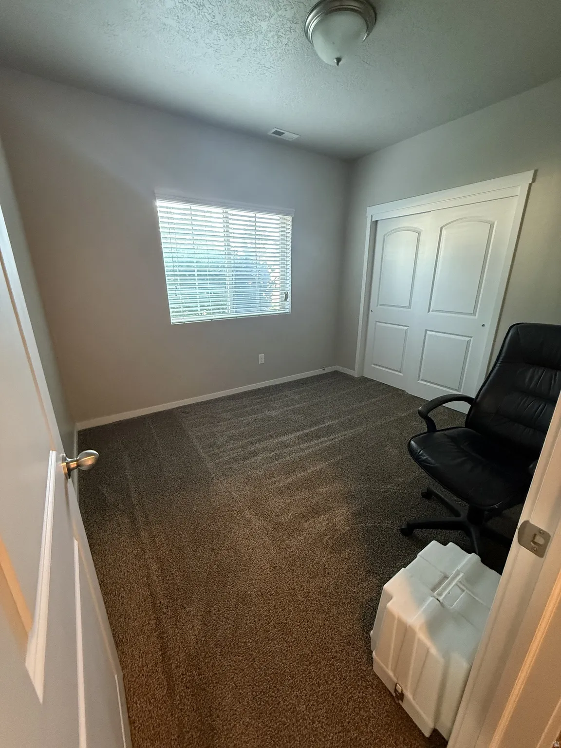 Neutral tone wall paint with a window featuring horizontal blinds