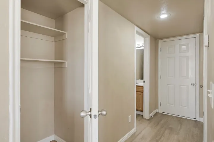 Entryway featuring light wood-finish flooring, a six-panel door, and a recessed ceiling light