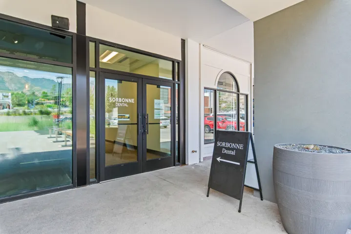 Modern commercial storefront featuring expansive glass panels and double entry doors
