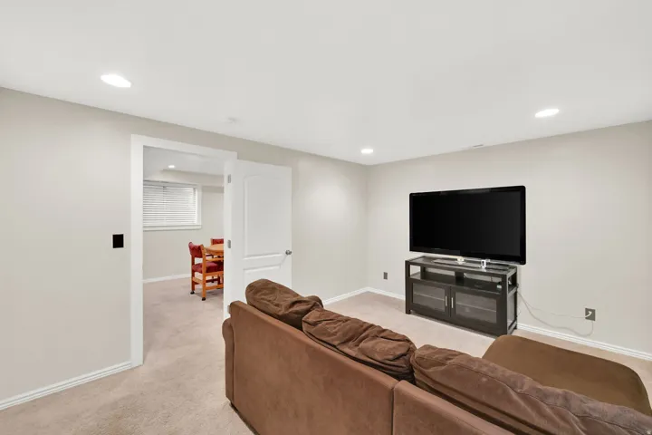 Recessed ceiling lighting, light neutral wall paint, white trim, and light carpeting