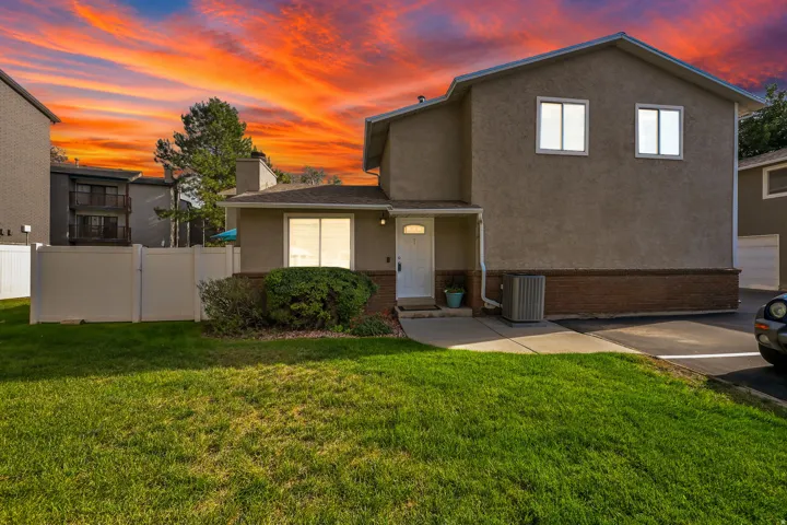 Stucco exterior with a brick-finish foundation