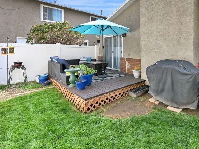 Private outdoor deck with lattice skirting and a sliding glass door