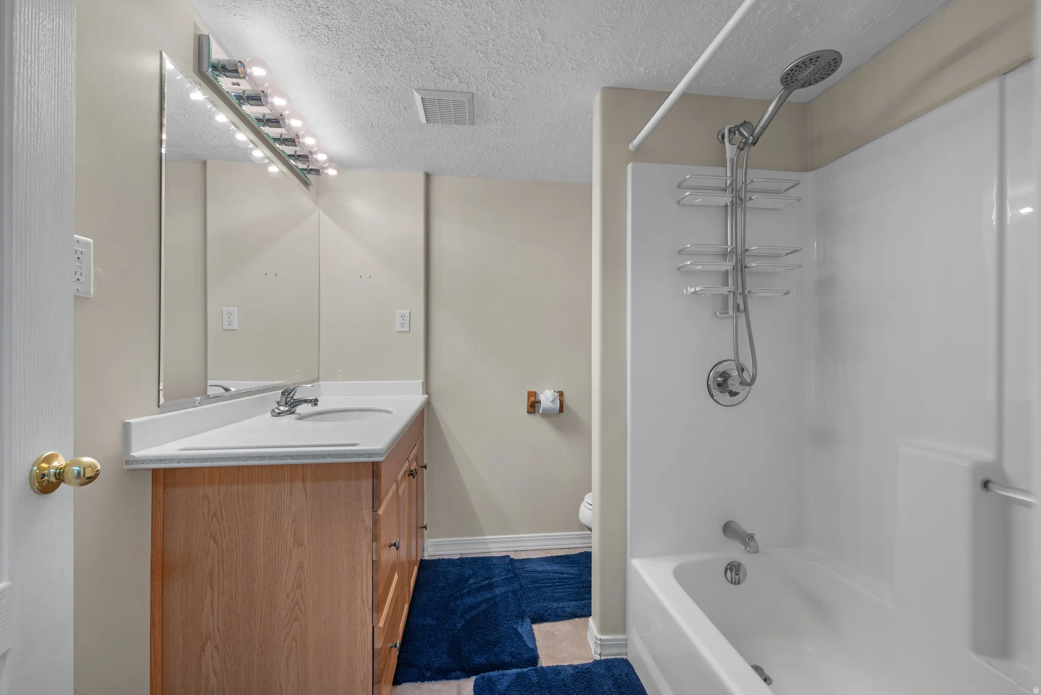 Wood-finish vanity with an integrated sink and chrome faucet