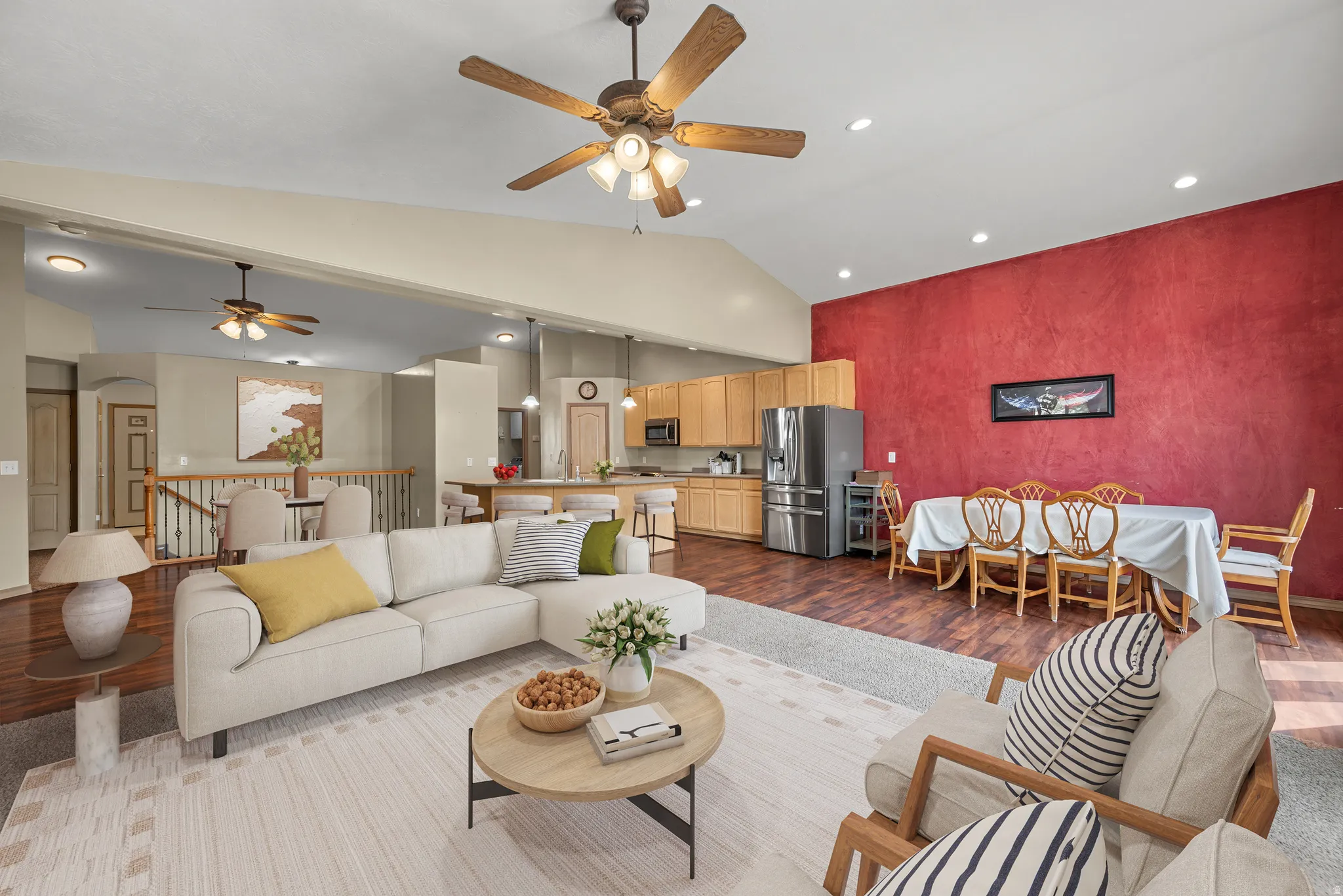 Vaulted ceilings with ceiling fans, recessed lighting, wood-finish flooring, and a kitchen with stainless steel appliances