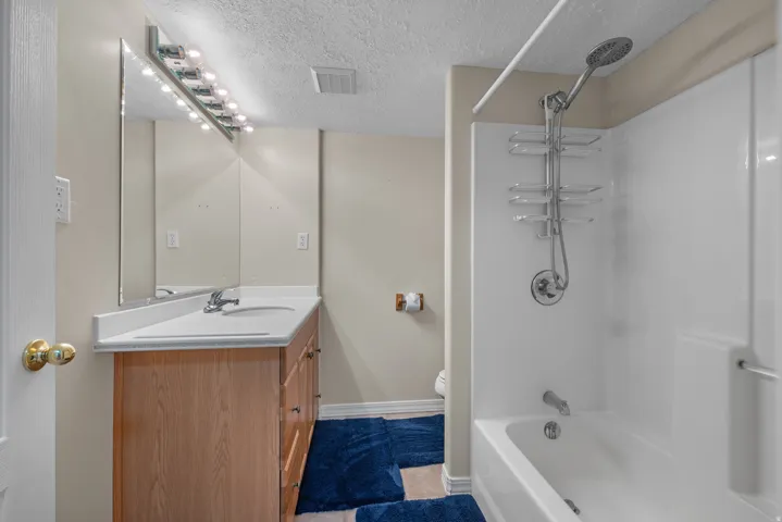 Wood-finish vanity with an integrated sink and chrome faucet