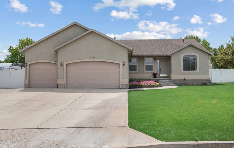 Tan stucco exterior with a gray shingle roof