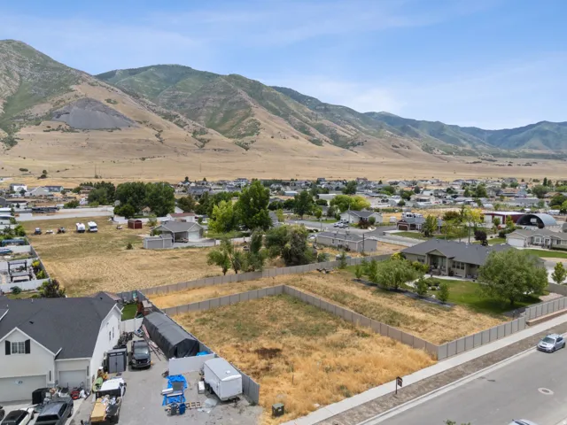Expansive level lot with established perimeter fencing, featuring a clear building area and direct street frontage
