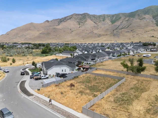 Expansive undeveloped lots featuring perimeter fencing, level topography, and mountain scenery