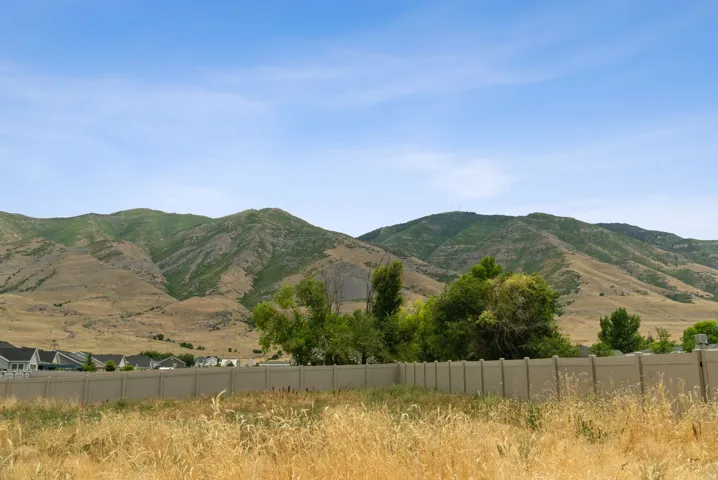 Expansive natural landscape featuring rolling hills and distant mountains