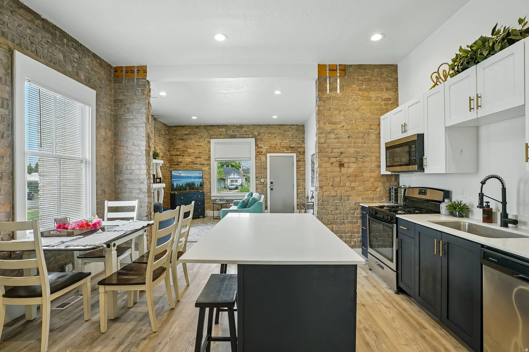 Modern kitchen with white and dark cabinetry, stainless steel appliances, and a central island