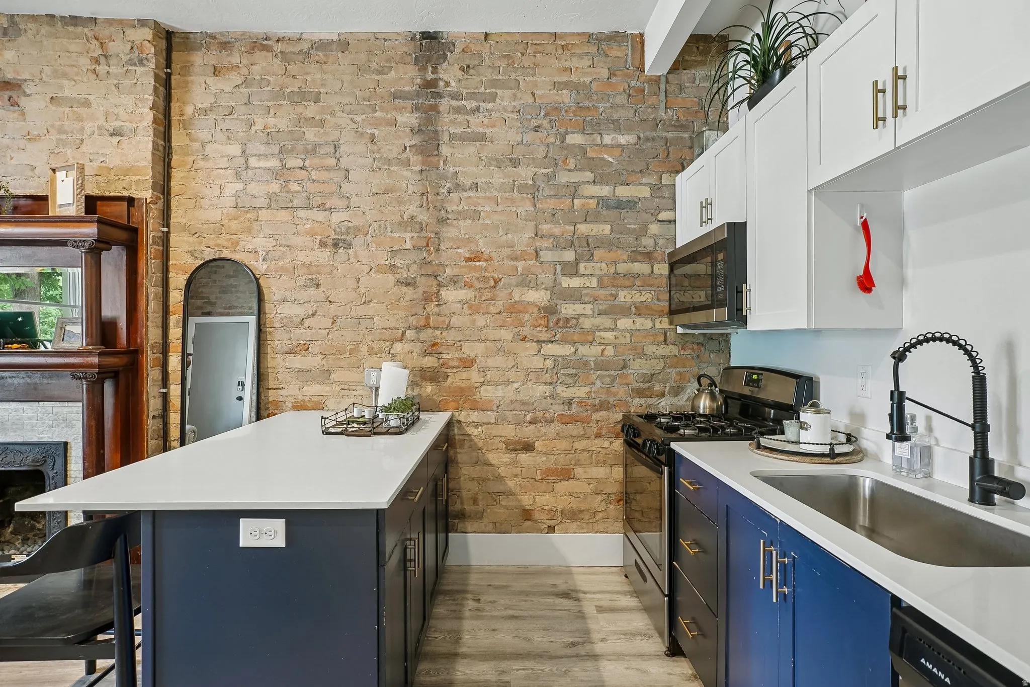 Contemporary kitchen featuring a dual-tone design with navy cabinetry, white upper cabinets, and stainless steel appliances