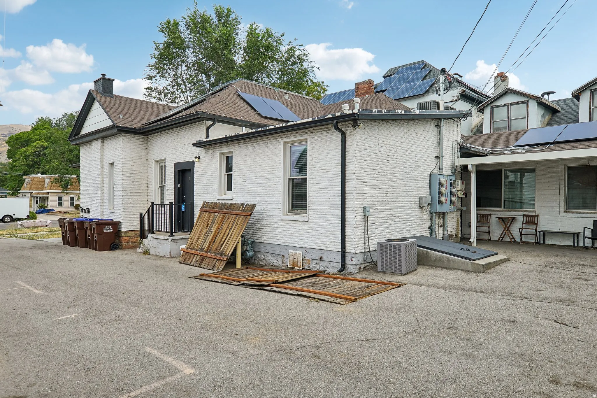 White brick exterior with modern solar panel installation on roof