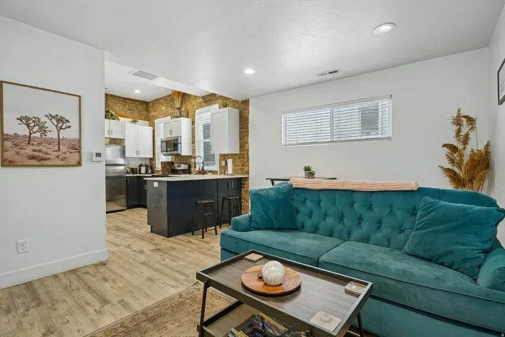 Open-concept living area featuring wood-finish flooring and recessed lighting