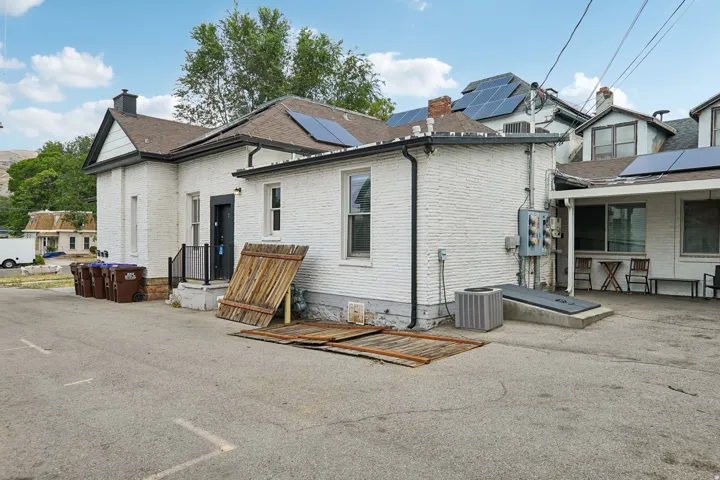 White brick exterior with modern solar panel installation on roof