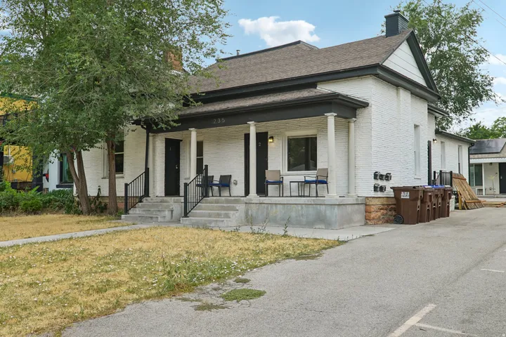 White brick exterior with a dark trim roofline