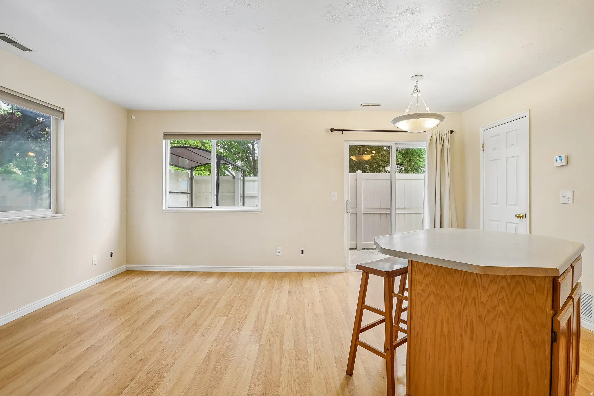 Light wood-finish flooring complements the neutral wall tones