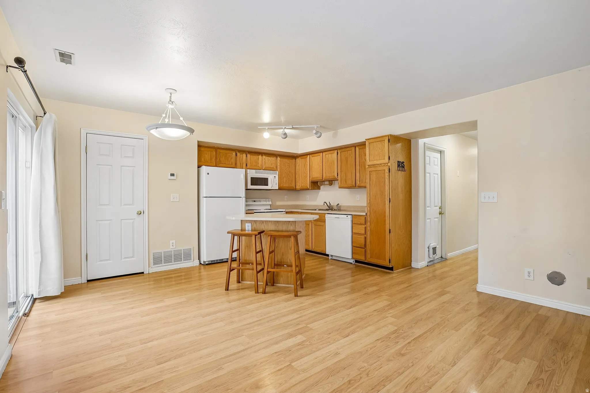 Open concept living space featuring light wood-finish flooring