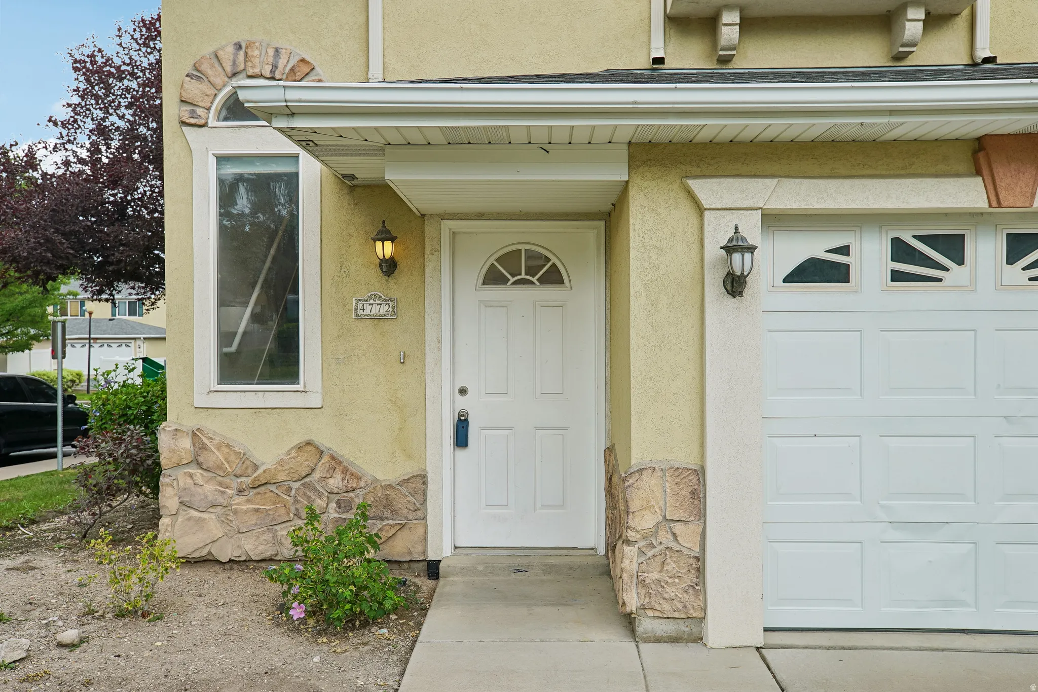 Stucco exterior with stone veneer accents