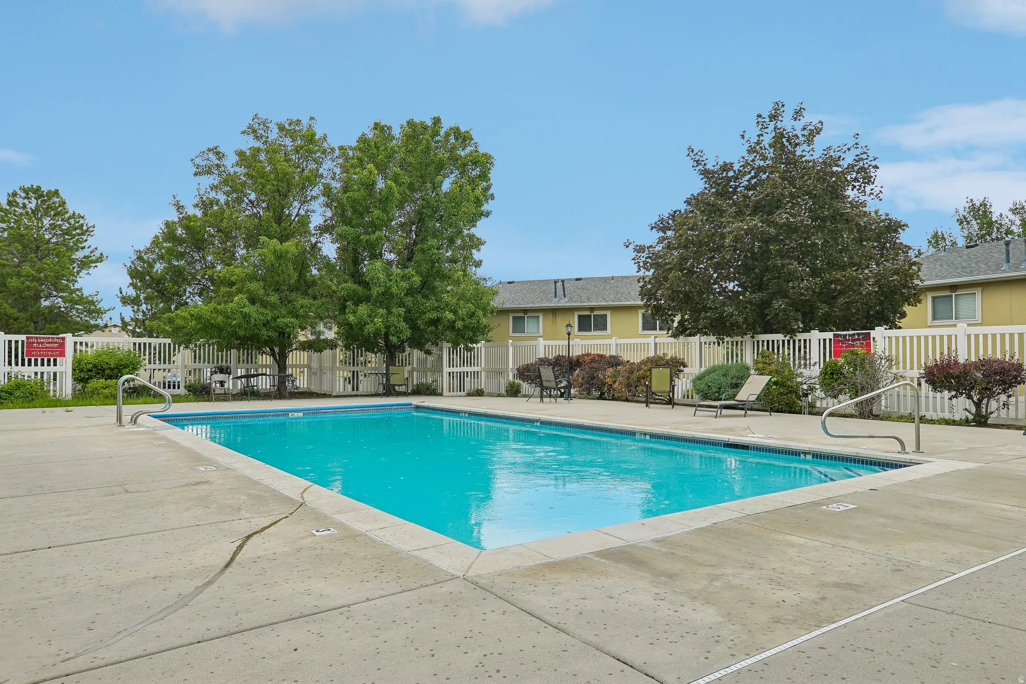 Rectangular inground swimming pool with a surrounding concrete deck