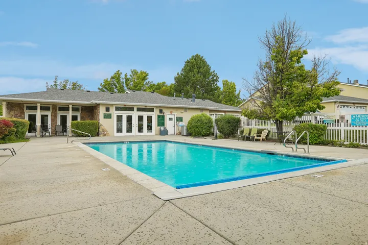 Outdoor swimming pool surrounded by a concrete patio