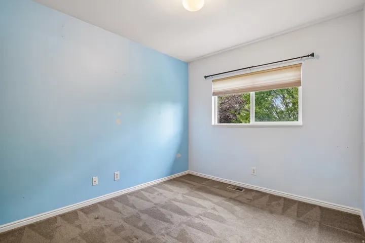 Light-filled room featuring a single window, recessed lighting, and carpeted flooring