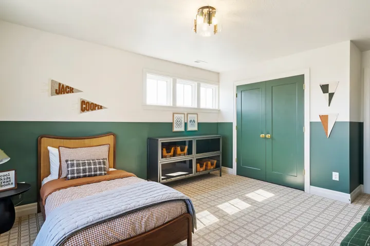 Room featuring a two-tone wall treatment, patterned carpet flooring, and a flush mount ceiling light fixture