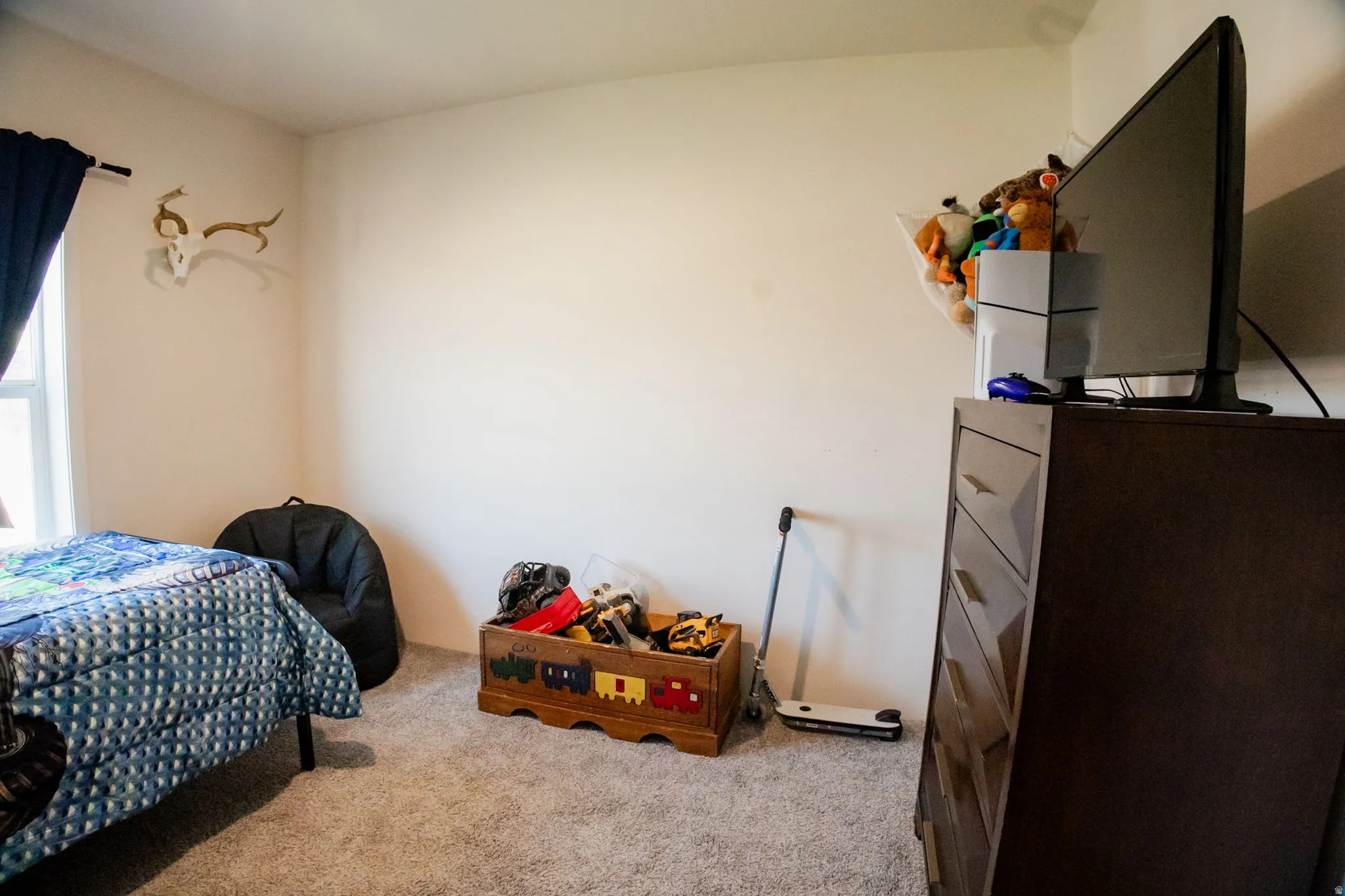 Carpeted interior room with white walls