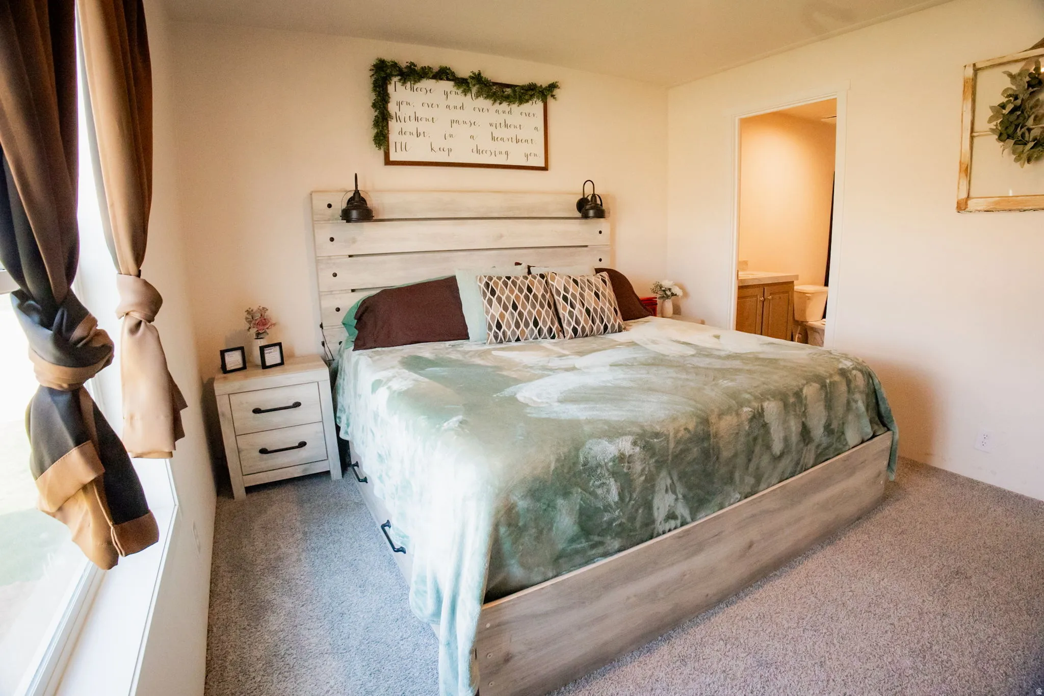 Bedroom featuring a wood-finish bed frame and matching headboard with integrated sconces