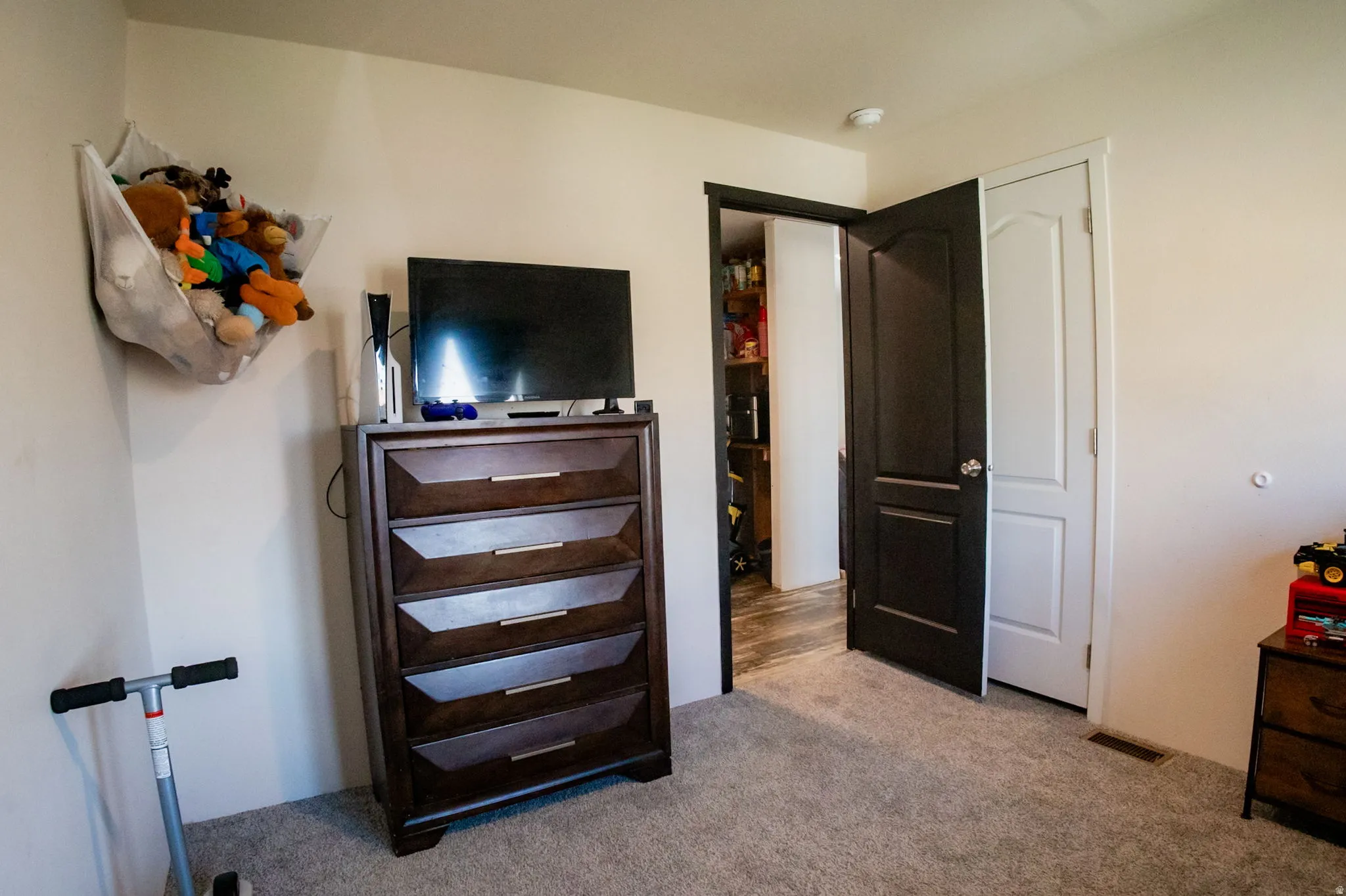 Wall-to-wall carpeting in a neutral tone, complemented by light-colored walls and contrasting dark interior doors