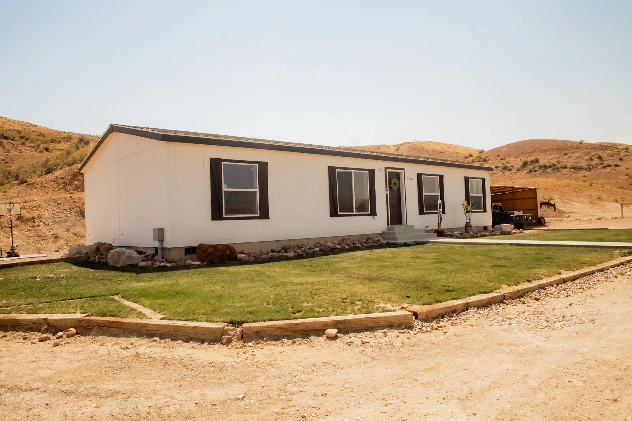 Single-story residence featuring white siding and dark trim windows