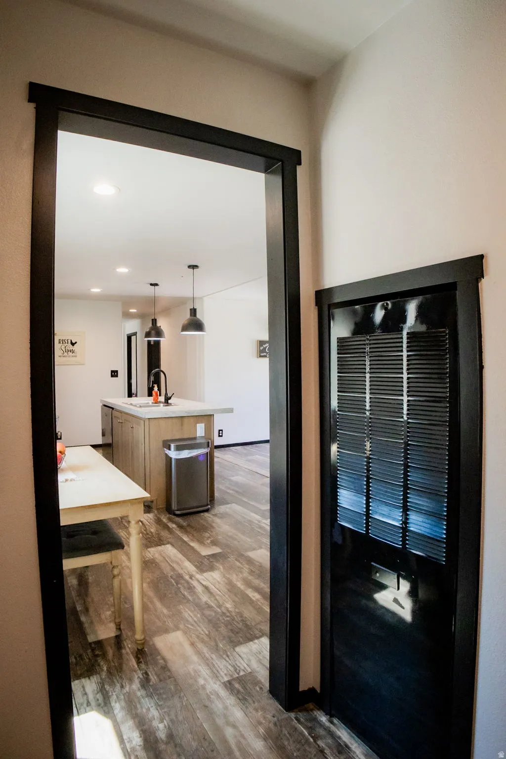 Kitchen island with a light-toned countertop and an undermount sink