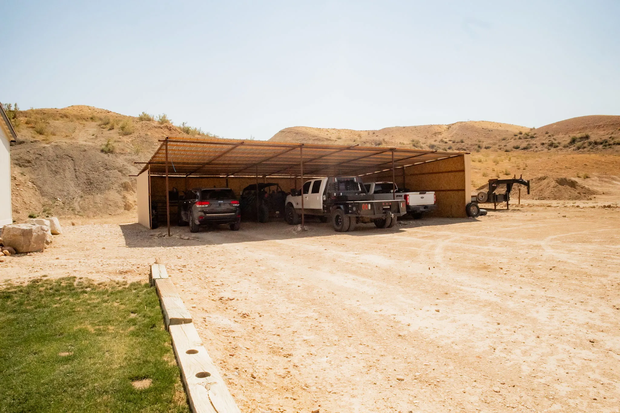 Open-air covered shelter providing vehicle storage